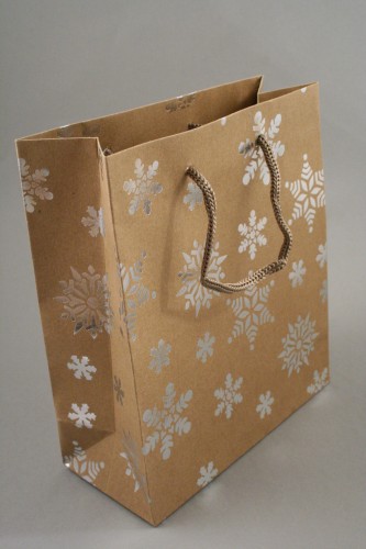 Natural Brown Kraft Paper Gift Bag with Silver Foil Snowflake Print and Brown Corded Handles. Size Approx 32cm x 26cm x 10cm.
